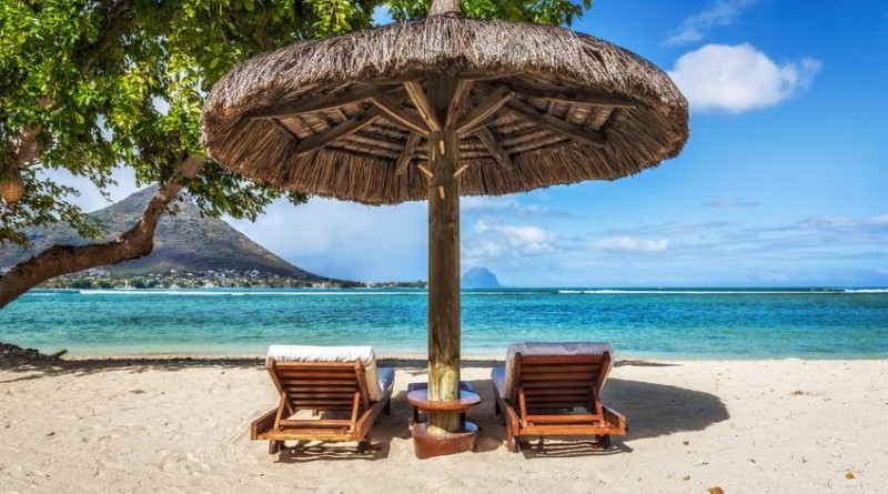 Loungers and umbrella on tropical beach in Mauritius Island, Indian Ocean