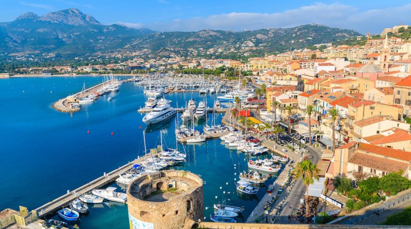 CALVI, CORSICA ISLAND - JUN 29, 2015: view of boats and colorful houses in Calvi port. This town has luxurious marina and is very popular tourist destination.